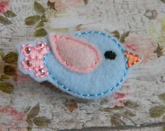 Adorable blue and pink felt birdie with pale pink Swarovski crystals on pale pink glitter grosgrain ribbon lined alligator clip