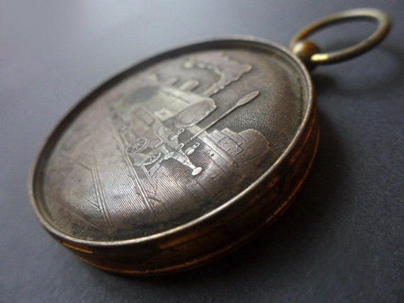 Vintage pocket watch case train medallion pendant.