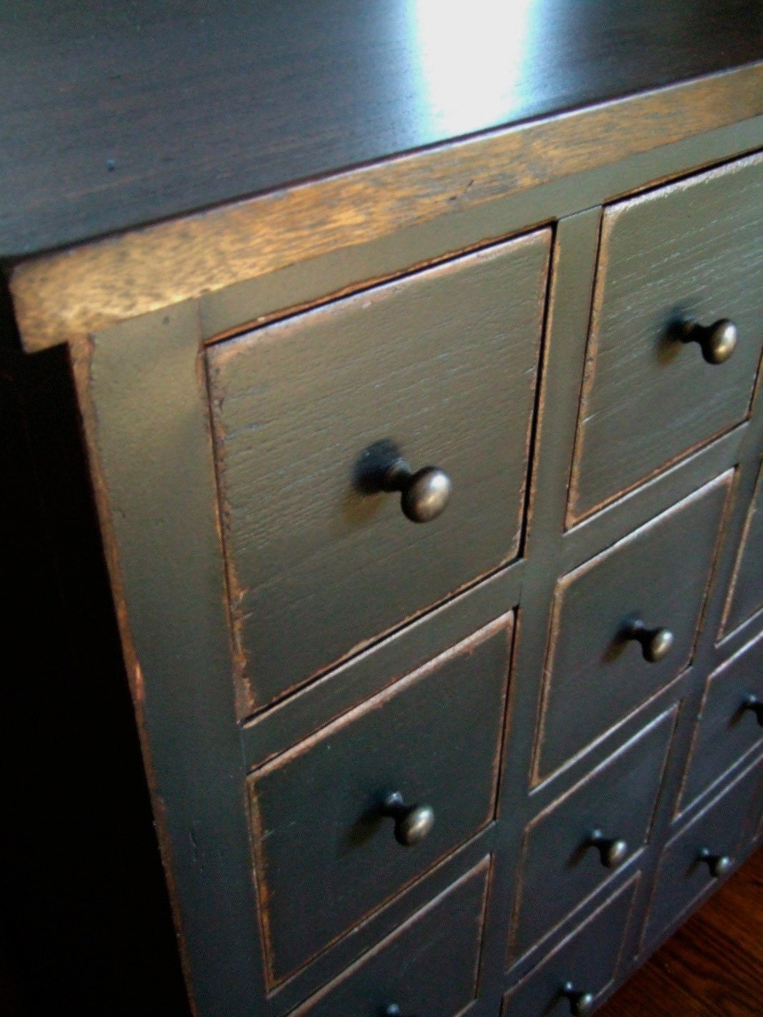Apothecary Chest in a distressed black with wood stained top.