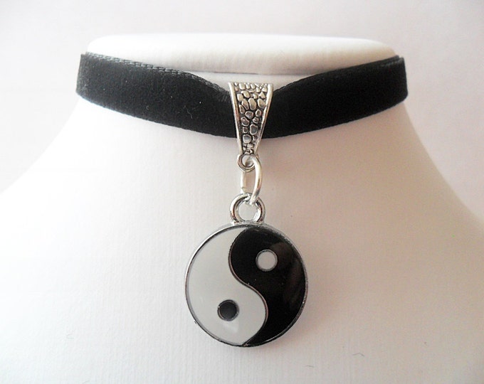 Black velvet choker with silver tone Yin and Yang charm pendant and a width of 3/8”inch.