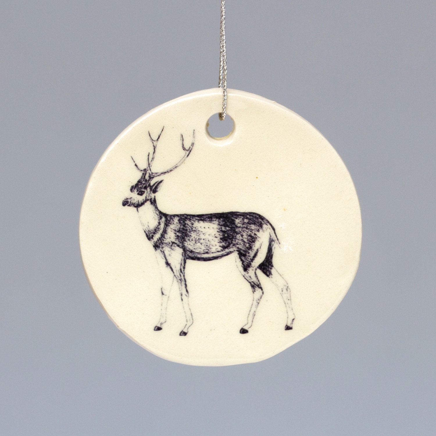 Ceramic handmade reindeer Christmas decoration. Hand illustrated design. Holiday gift, stocking filler.