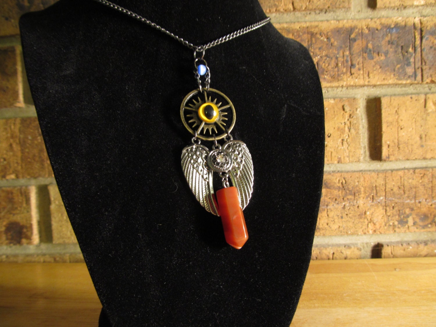 Steampunk Winged Red Quartz Necklace with yellow eye. steampunk buy now online
