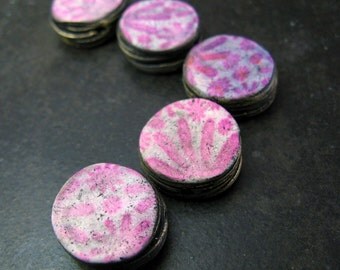 Neon pink and distressed black circular strata beads in polymer