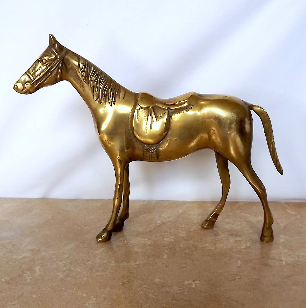 Vintage brass horse brass racehorse with saddle
