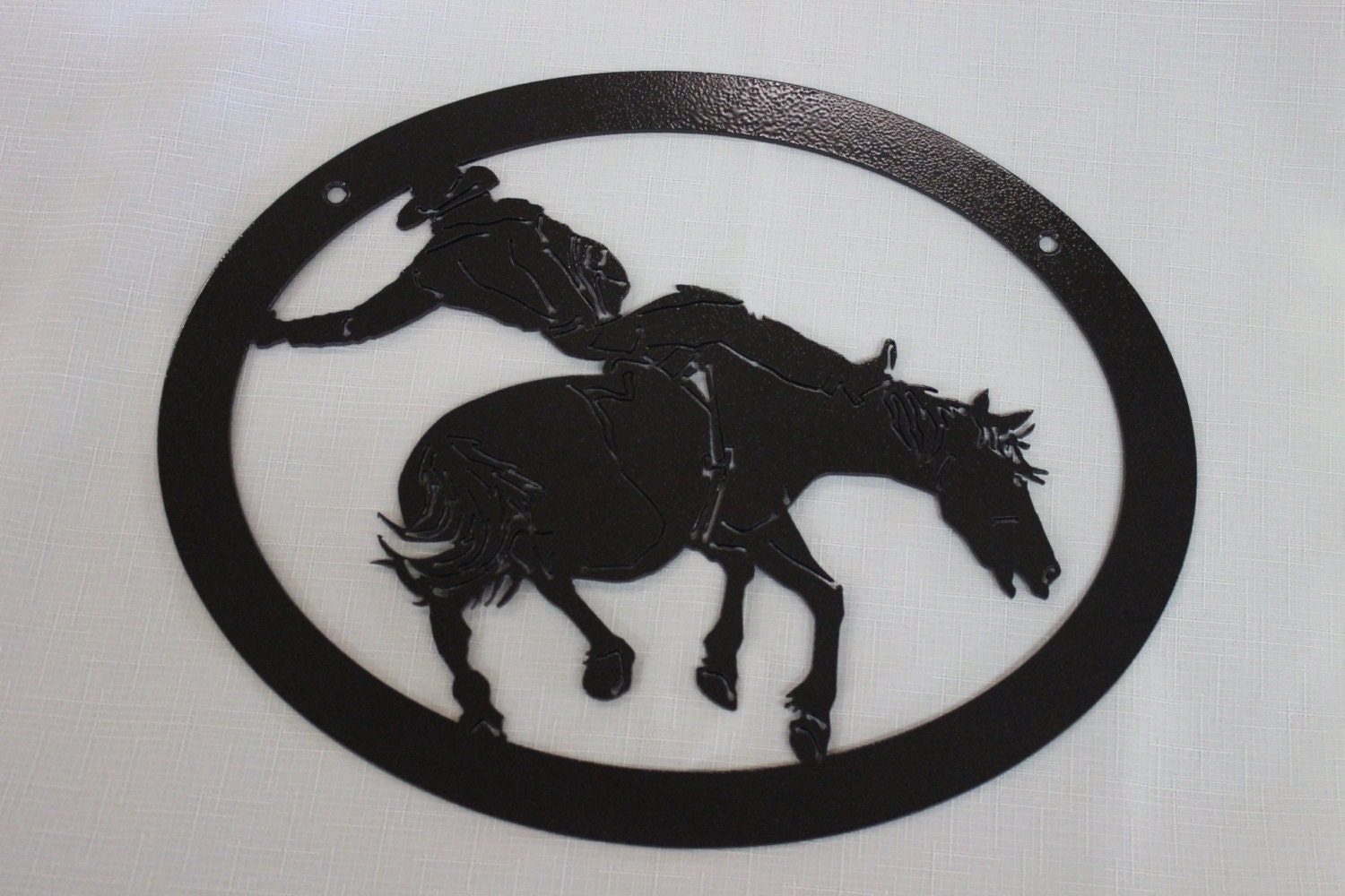 Custom metal wall art with bucking bronco.