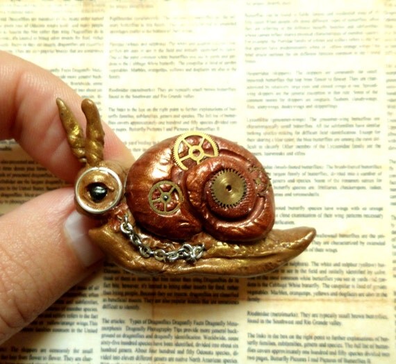 Cute Steampunk Snail Brooch, handmade from polymer clay using watch parts and monacle