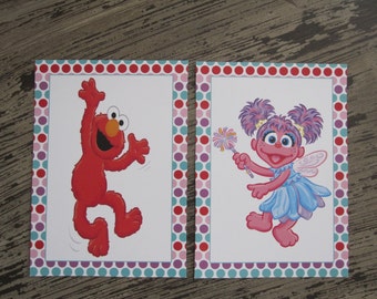 elmo holding a number 2