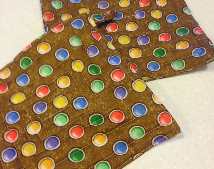 Set of two quilted hotpads with loops for handing. Brown with polka dots.