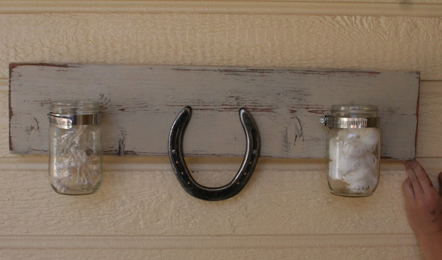 Distressed towel rack with horseshoe and mason jars