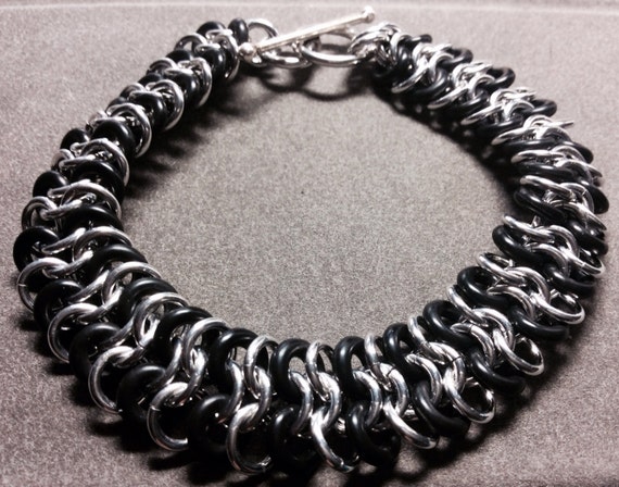 Chainmaille bracelet. Custom fit. Black and silver in color. 1/2 inch wide. The black rubber gives this bracelet a bit of stretch.