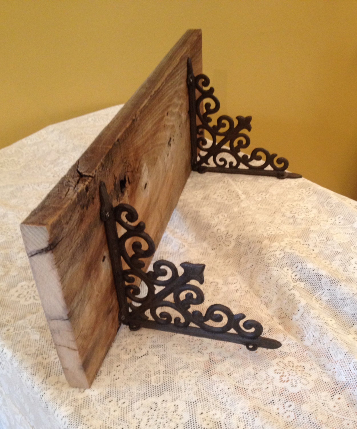 115 year old barn wood shelf with wrought iron scroll bracket