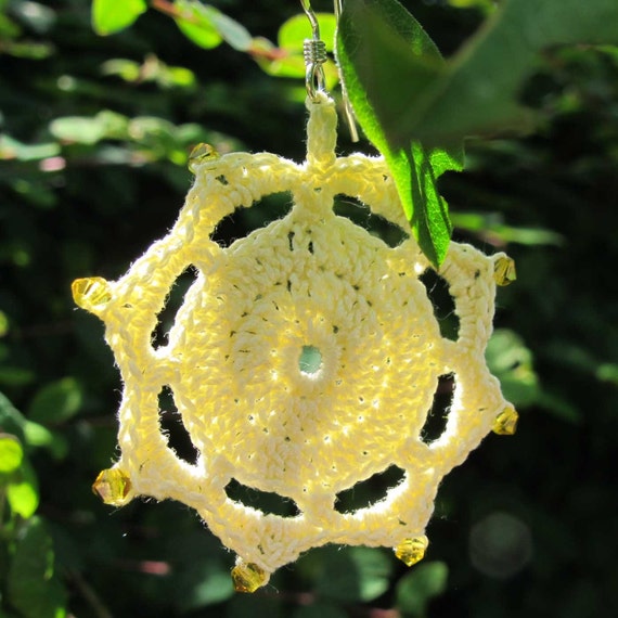 Crochet sun earrings in pale yellow with Swarovski crystals