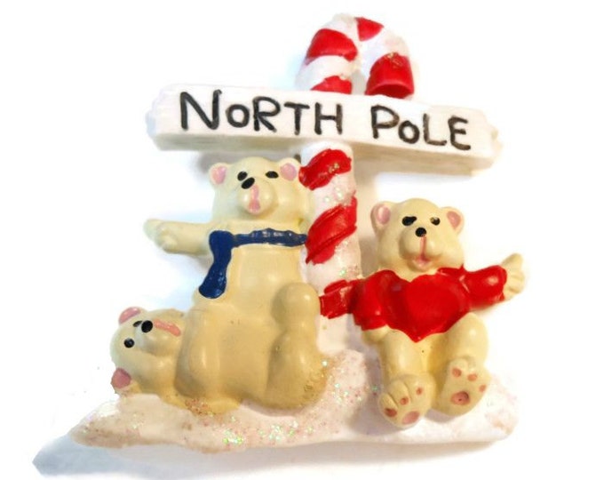 Christmas brooch - which way to the North Pole now? Three bears hitchhiking their way to the North Pole in front of a candy cane road sign