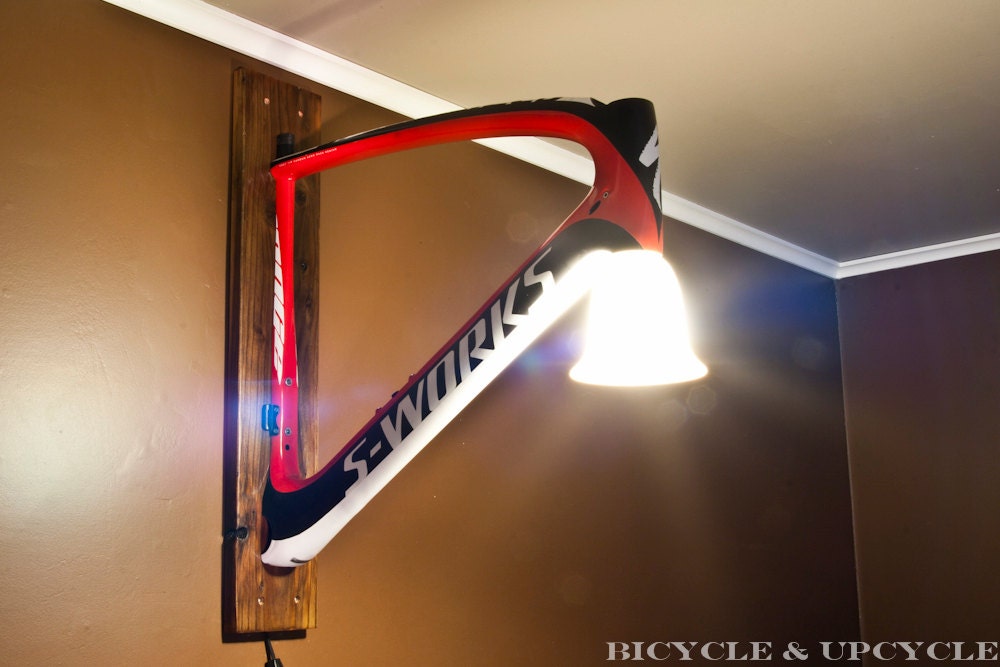 Unique handmade upcycled bike frame wall lamp. Recycled bike