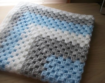 Hand crocheted baby blanket. In blue, pale grey and white. Suitable for car seat, crib, pram or moses basket. Ideal just to wrap baby in.