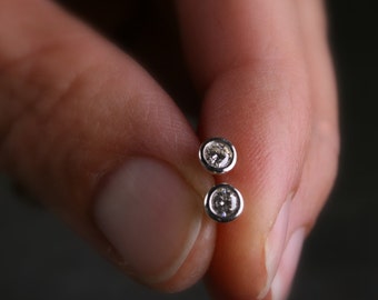 Tiny bezel set round brilliant cut moissanite stud earrings set in sterling silver 3mm .25 carat tw