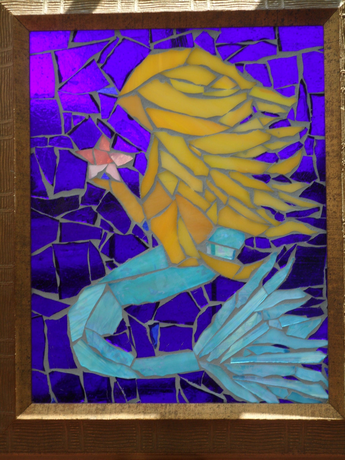 Stained glass mosaic mermaid in iridescent blue.