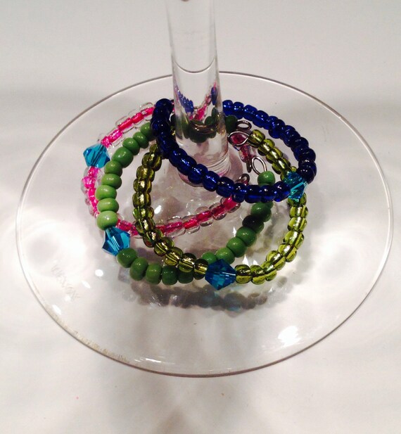 Items similar to 4 wine glass rings with blue crystal on Etsy