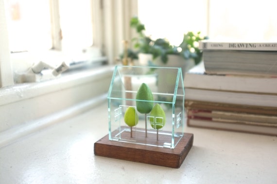 Miniature greenhouse structure - small acrylics architecture around green trees - glass house -look solarium