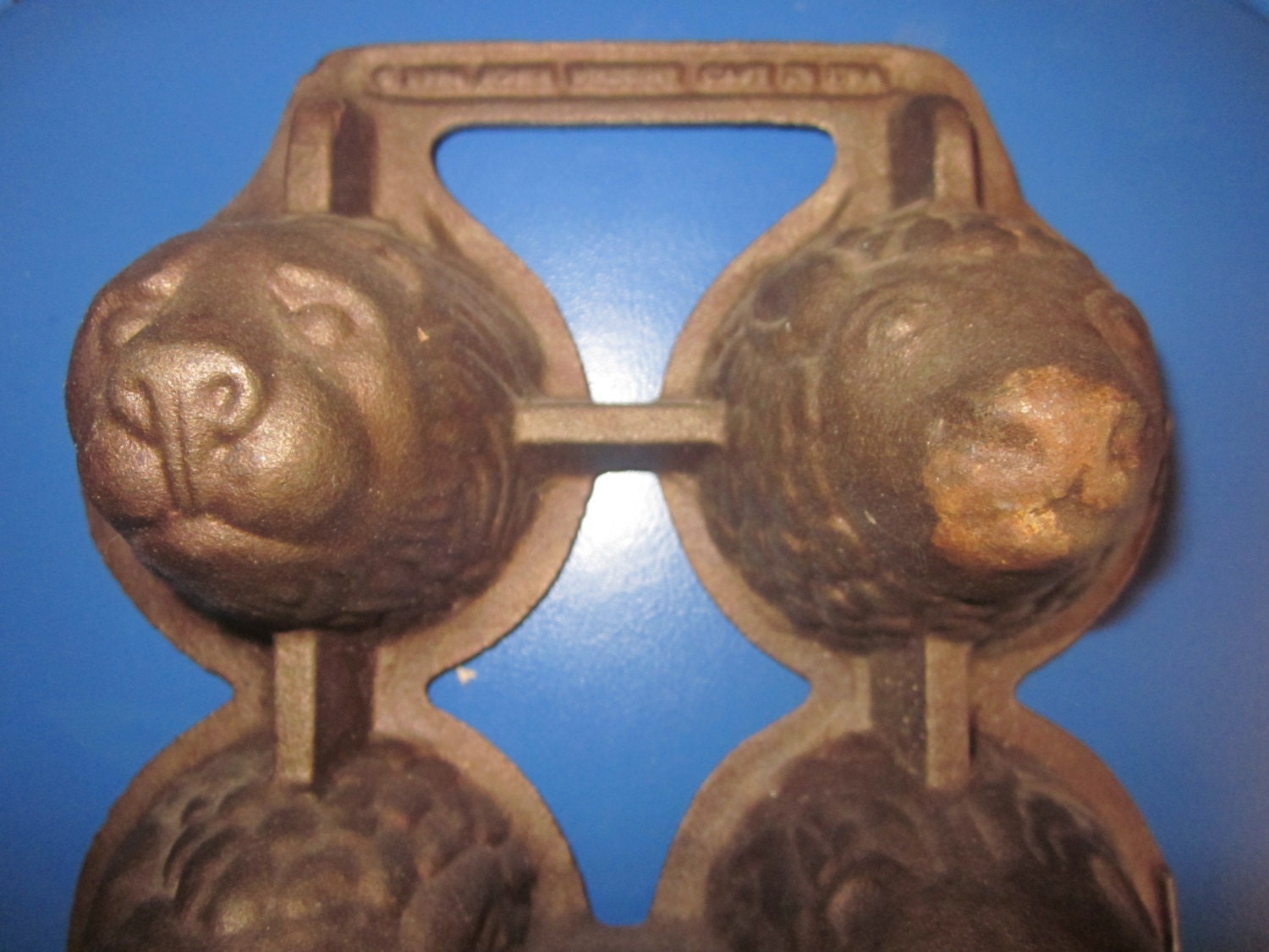 cast iron popover pan. lamb and lion heads