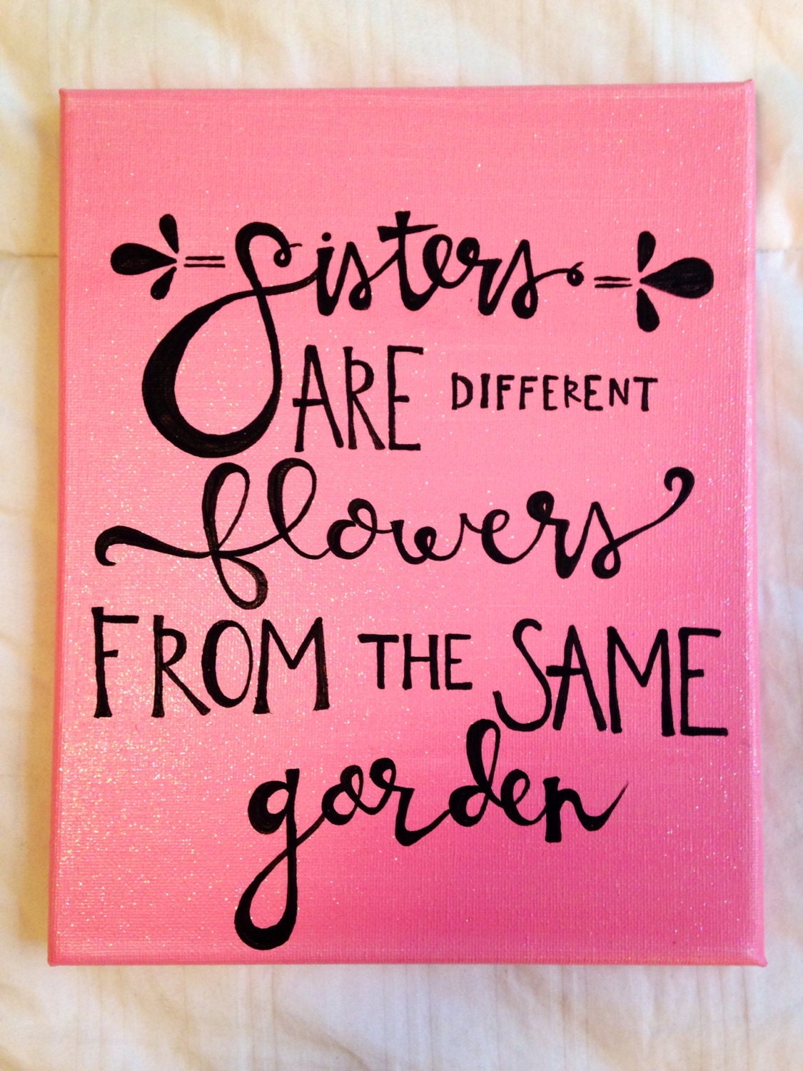 Canvas quote sisters are different flowers from the same