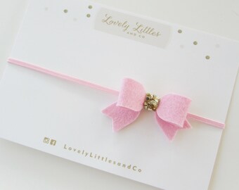 Girl/Baby, Baby Pink Mini Felt Bow on pink skinny elastic headband with gold glitter fabric detail.
