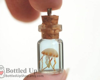 Tiny Glow-in-the-Dark Jellyfish in a Bottle pendant on necklace.