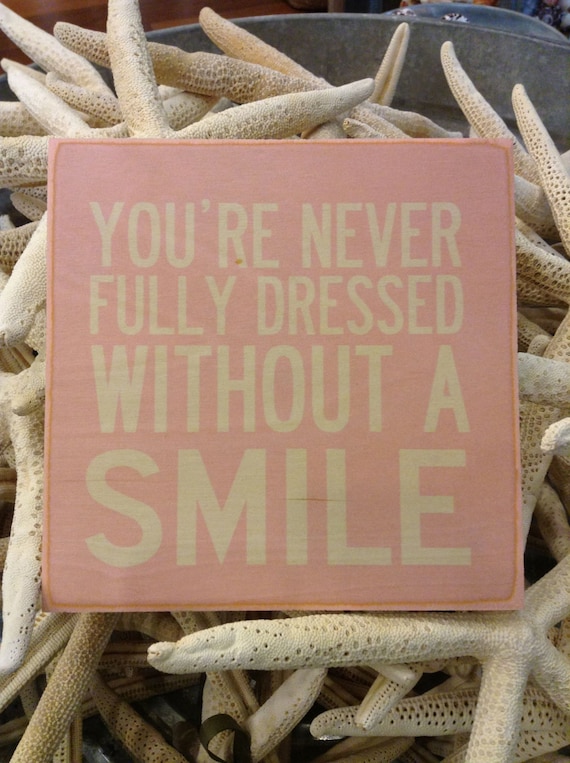 Items similar to You&#39;re Never Fully Dressed Without a Smile Wooden Hanging Sign on Etsy