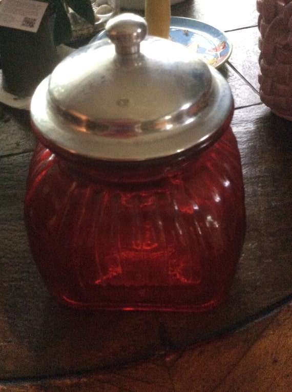 Vintage red glass cookie jar with metal lid