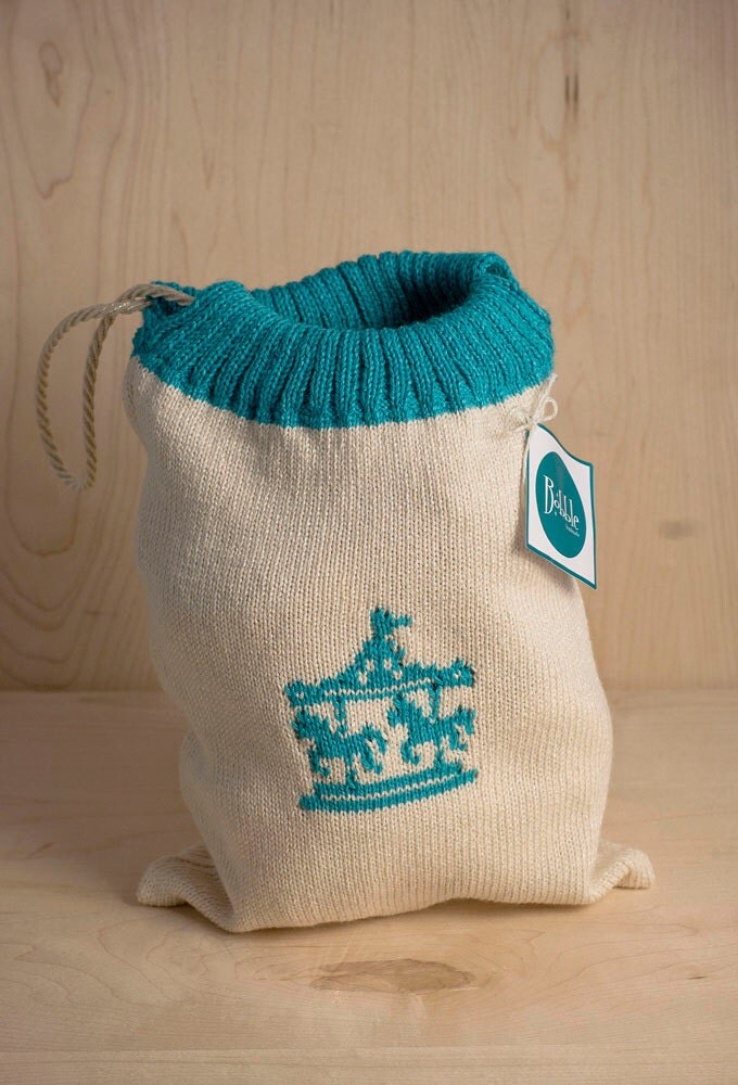 Mini knitted drawstring bag with carousel motif by ...