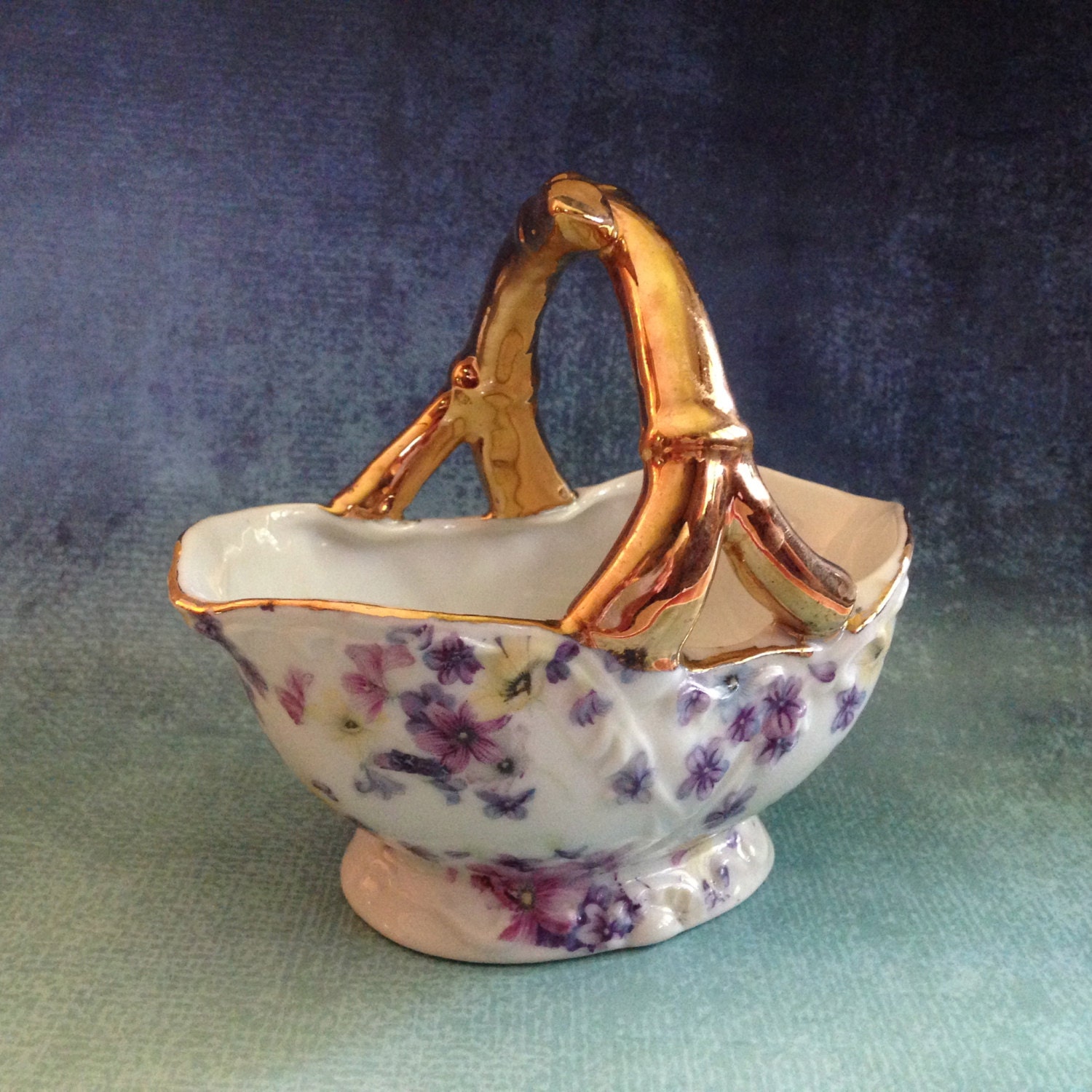 Vintage small ceramic flowered basket with gold handle