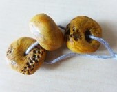 Faux Ancients in Ivory/Amber/Bone. Polymer clay artisan wheel beads.