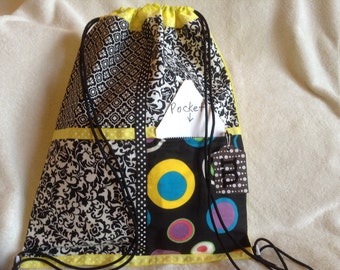 Yellow against black and white on a yellow ripstop nylon drawstring backpack with front zipper pocket