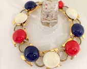 Vintage red white and blue bracelet, cabochons of enameled metal sit upon gold metal hourglass shapes, statement bracelet, July 4th