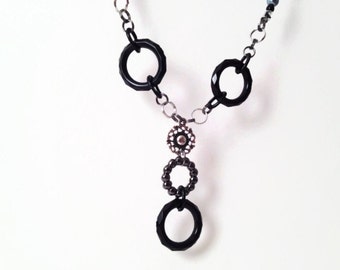 Black circular necklace with silver accents