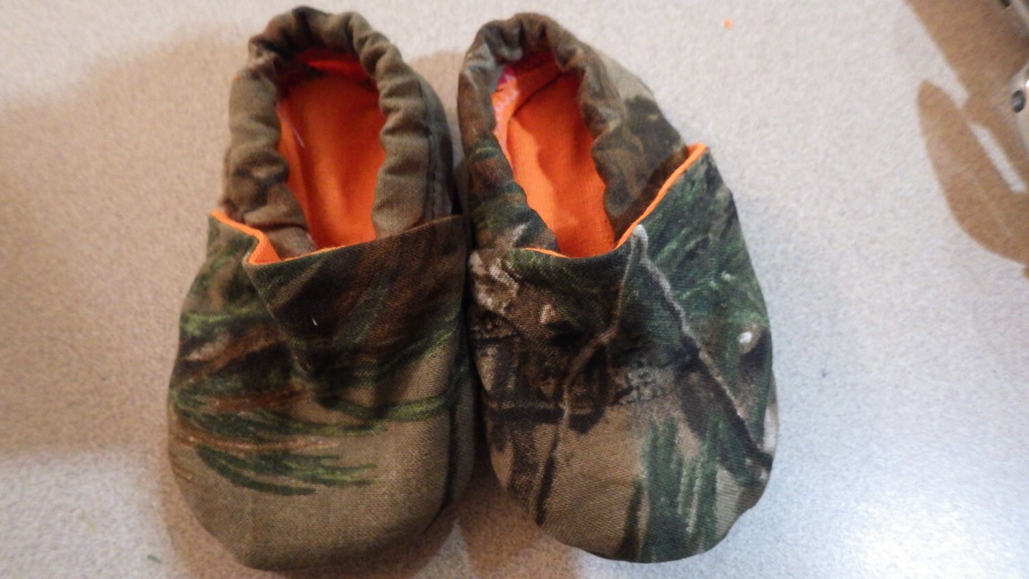 Realtree camouflage crib shoes with blaze orange lining