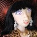 Cloth doll, 16 inches tall in leopard print dress holding roses, named Victoria