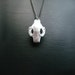 Cat Skull Necklace in white - A white cat skull necklace on a gunmetal chain to adorn your neck