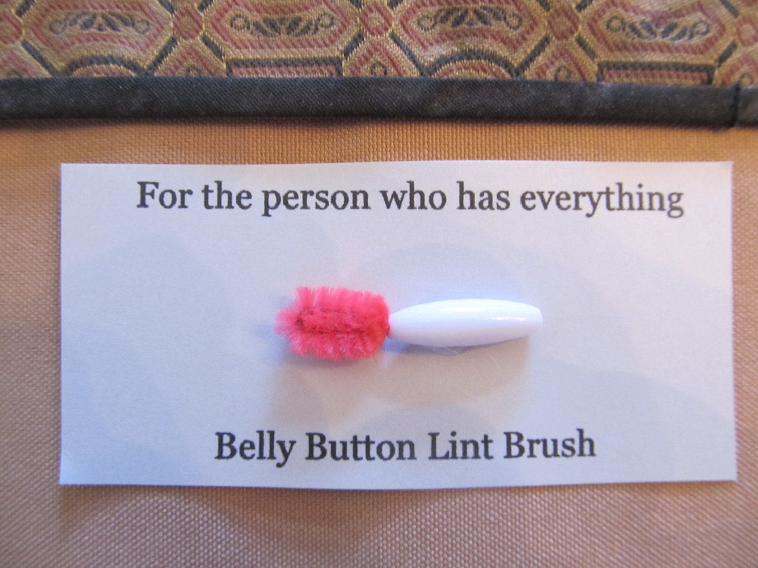 belly button lint brush for the person who has everything