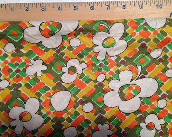 1960's Flowered and geometric fabric in orange, yellow, and greens.
