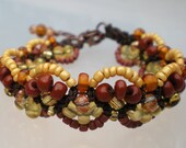 Square knot fan micro macrame bracelet beaded in tempting shades of chocolate, caramel, and peanut brittle on brown nylon cord.