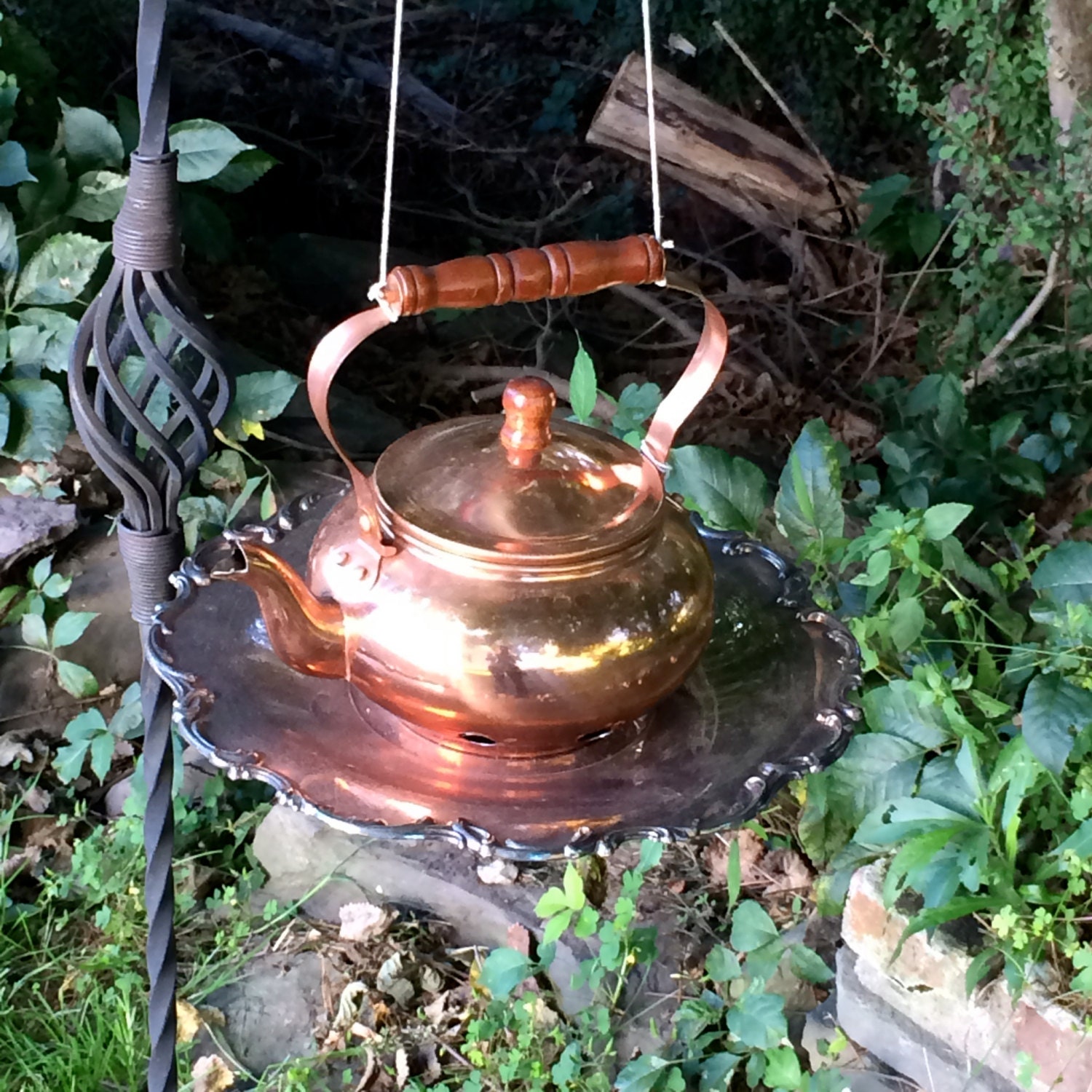 Repurposed copper tea pot bird feeder