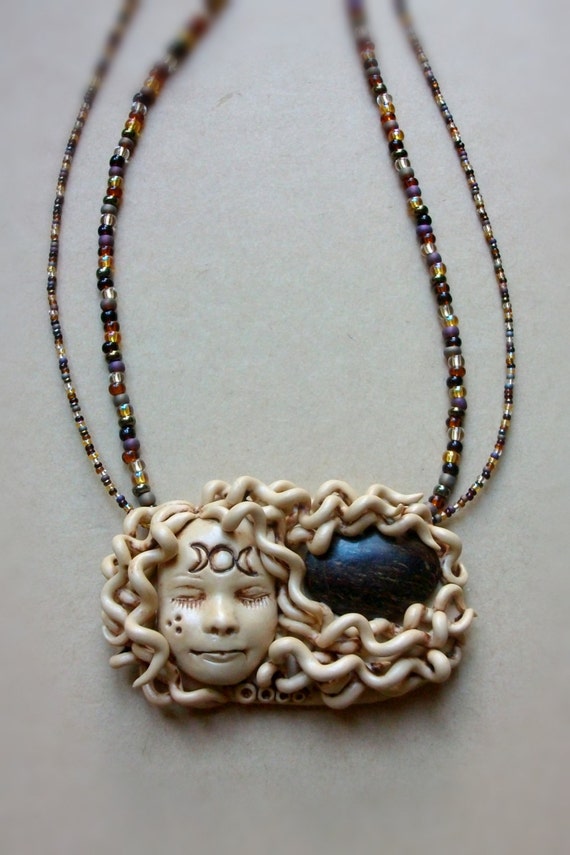 Items similar to Polymer clay goddess pendant with bronzite and glass