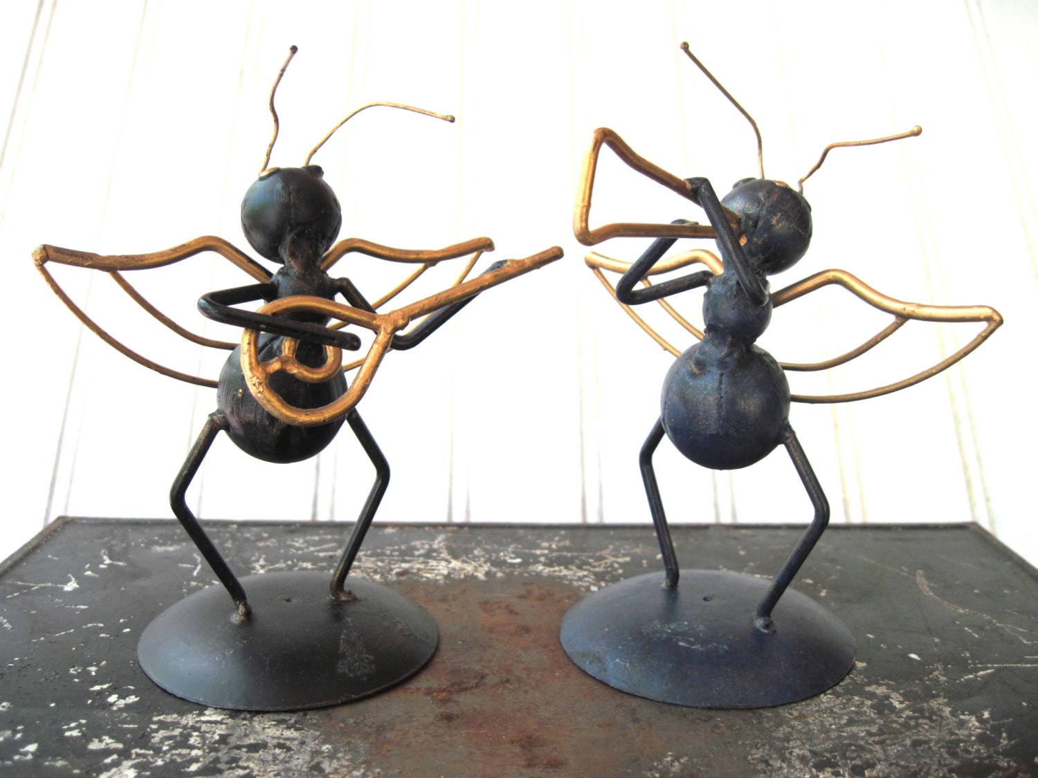 Vintage metal ants playing instruments anthropomorphic bugs