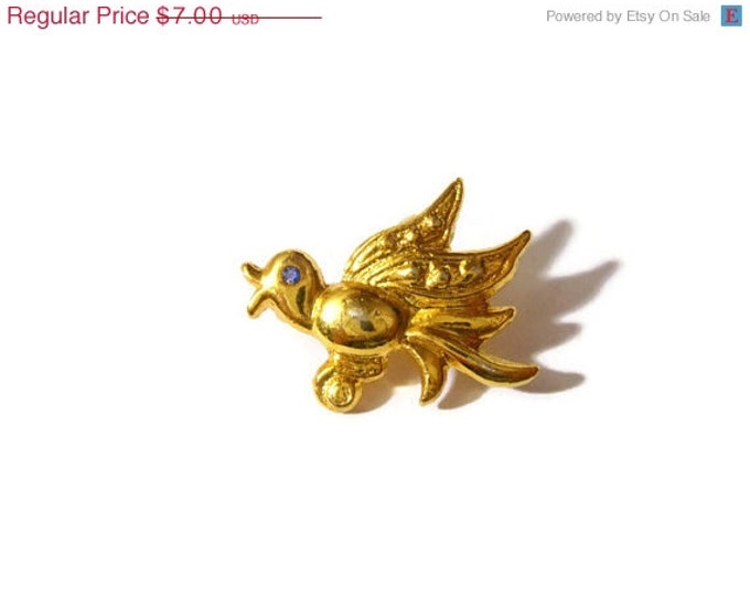 Cute little gold tone bird brooch with blue rhinestone eyes