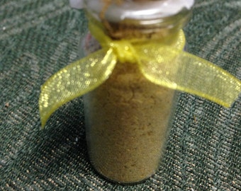 Goddess Ochun powder incense in a corked glass bottle