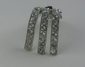 Age old, elegant clothes clip / clothing clip made made of silver metal with rhinestones. Vintage