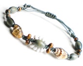 White daisy and tan dove shell micro macrame bracelet on washed denim nylon cord.