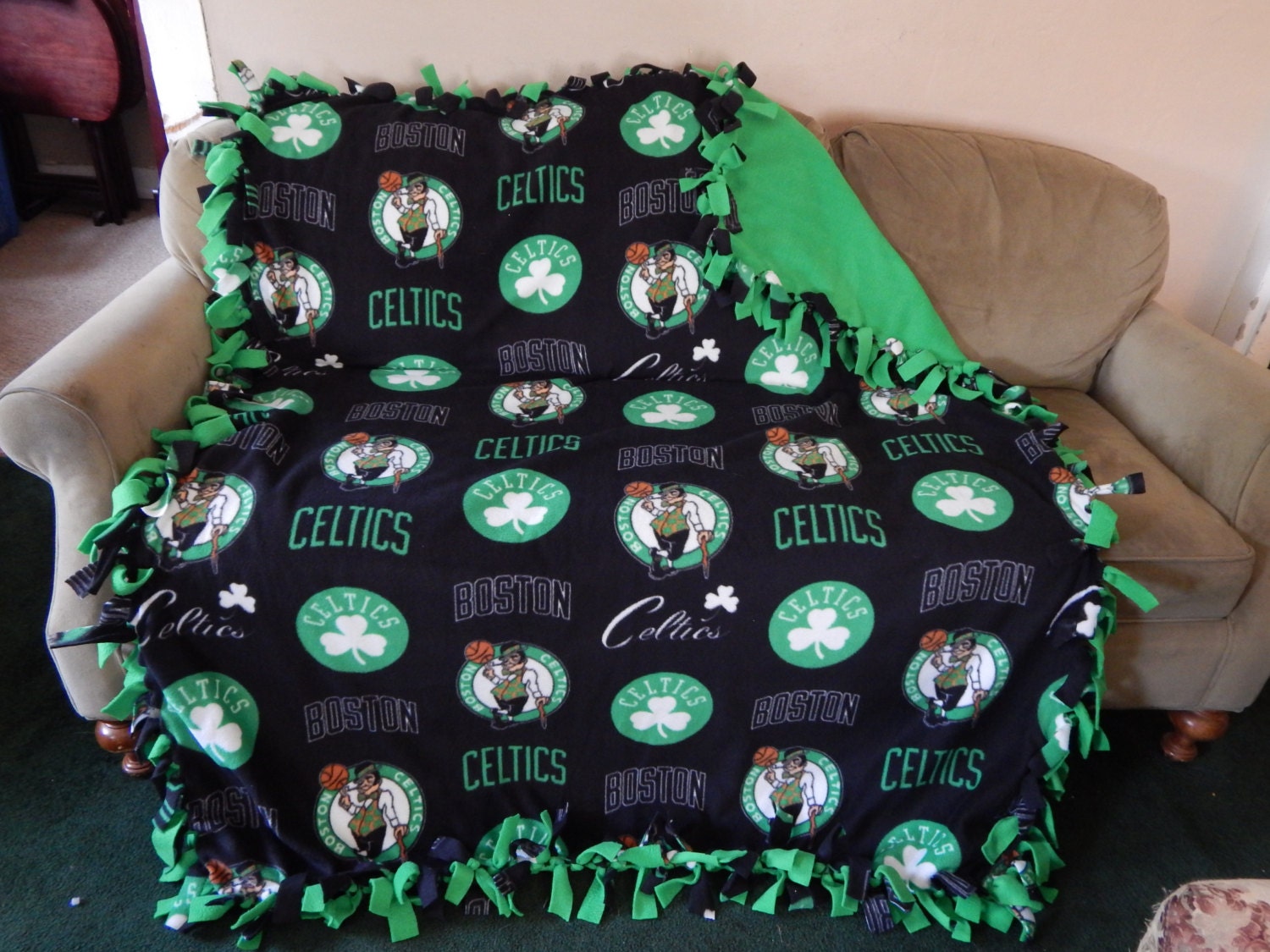 This is a Boston Celtics Basketball Team Blanket made of