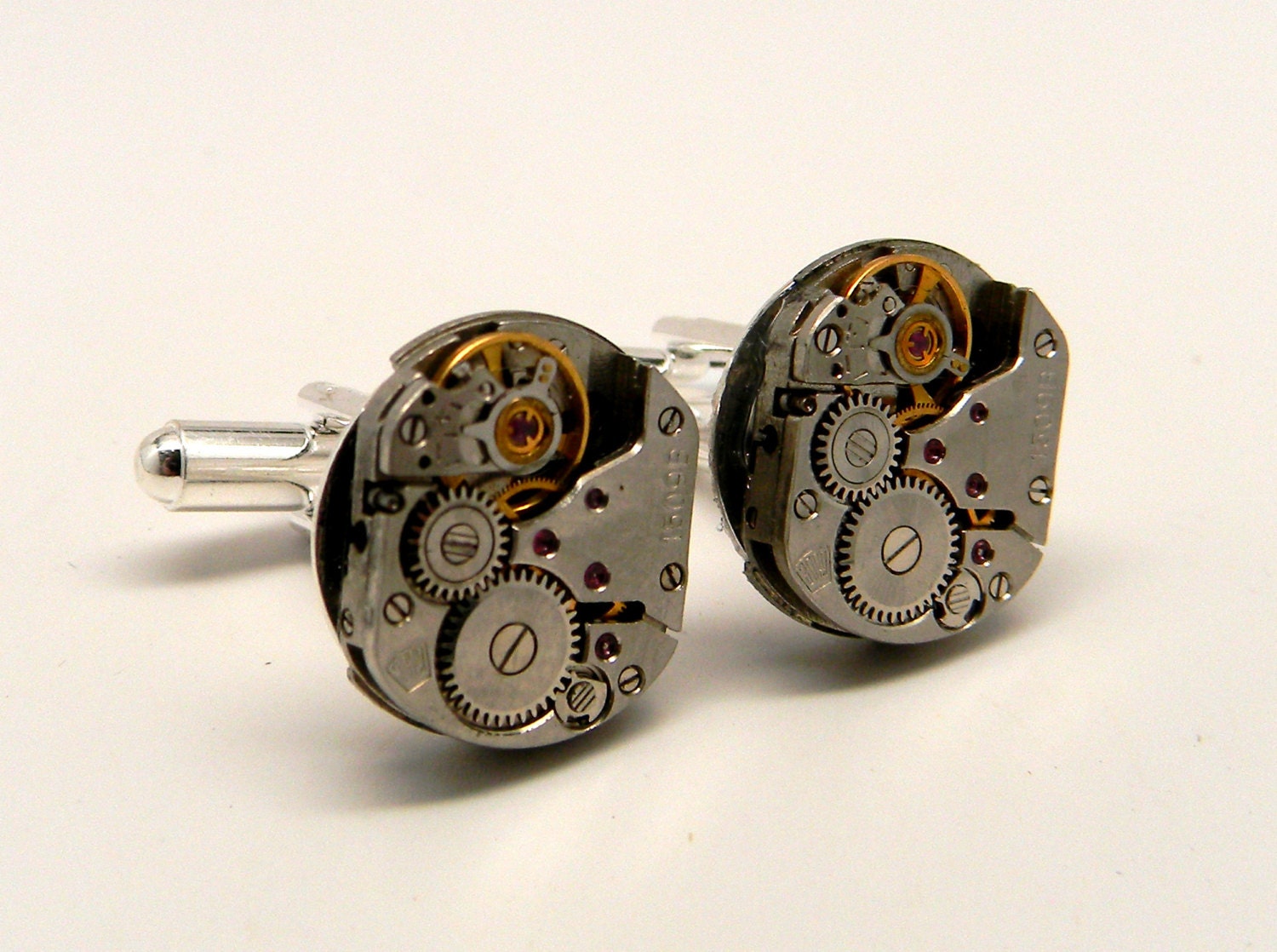 Steampunk cuff links with vintage watch movement.